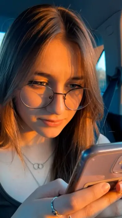 Creator looking down at her phone in disbelief
